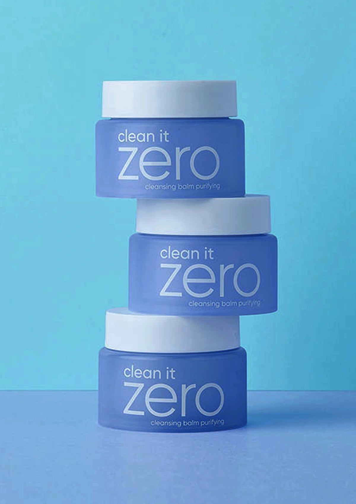 Stack of 'clean it zero' skincare products on a blue background